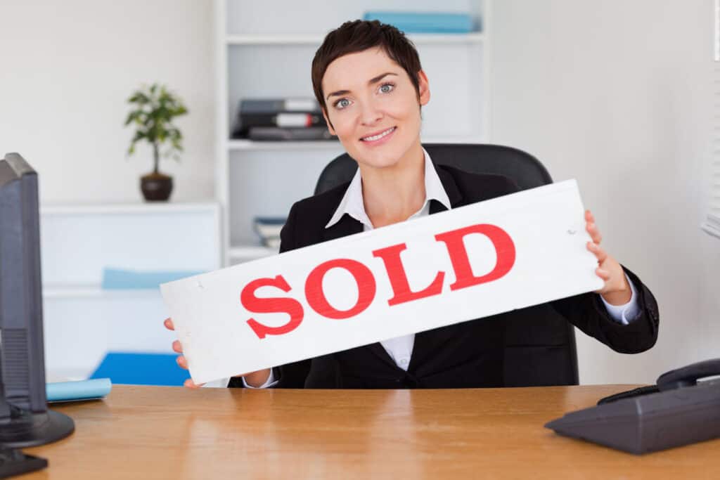 Real Estate Agent with Sold Sign